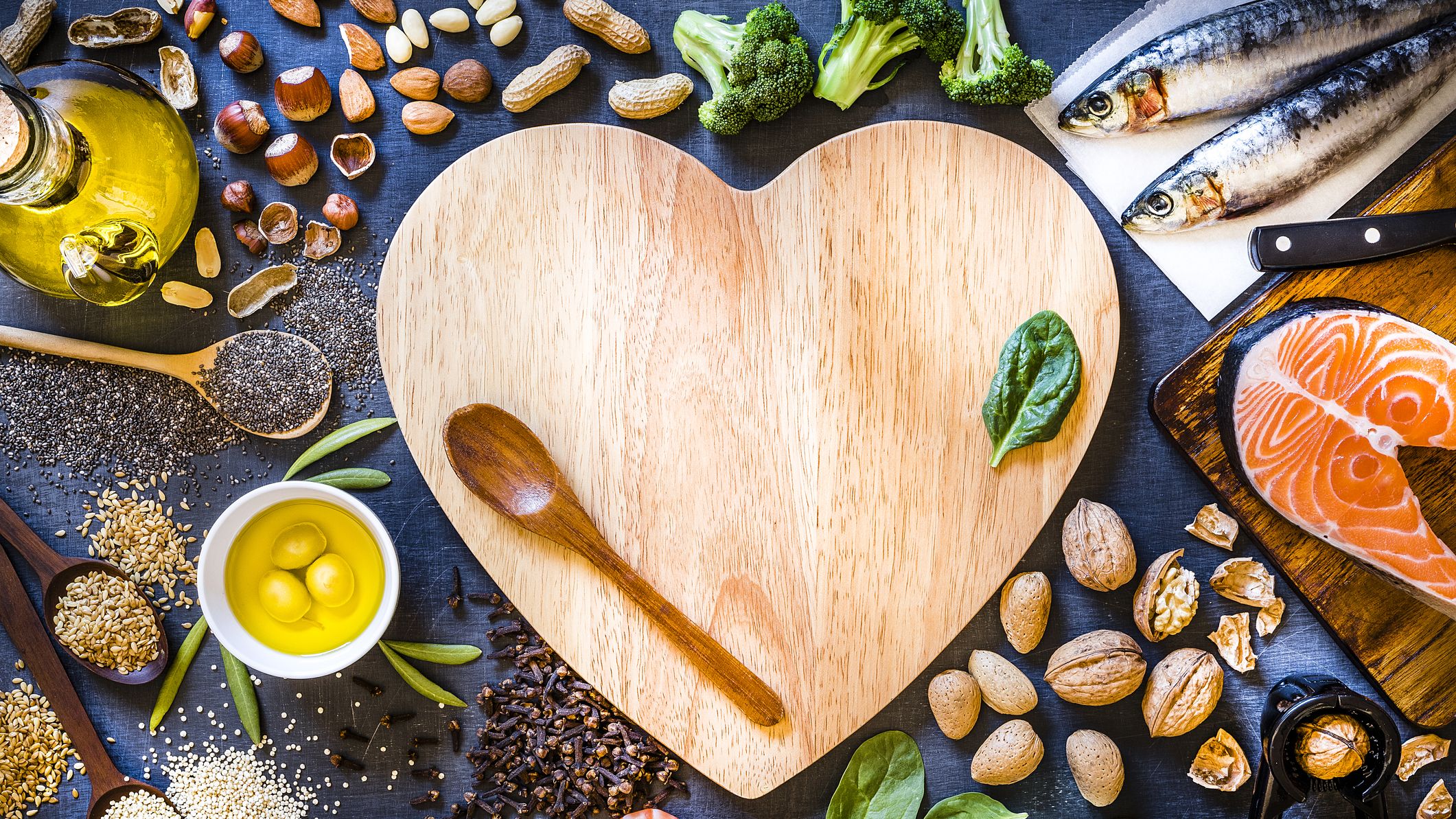 A Wooden Heart Surrounded by Vegetables and Cooking Oil